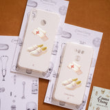 a couple of cell phones sitting on top of a table