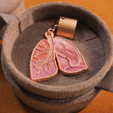 Close-up of a gold-plated lung anatomy stethoscope charm