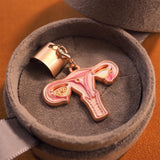 Angled view of a uterus anatomy stethoscope charm in a velvet gift box